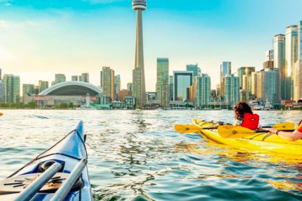 people kayaking with view of toronto city skyline