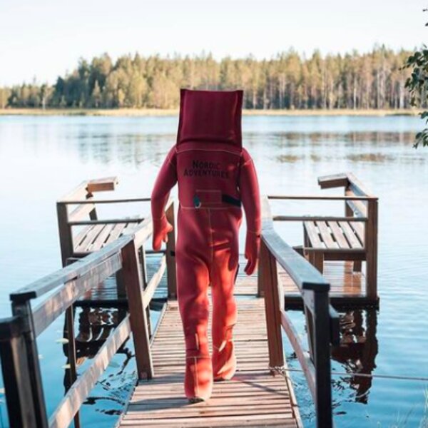 person in floating swim suit at lapland lake