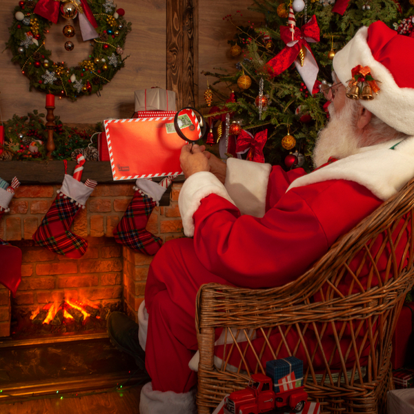 santa reading letters at his cottage in ruka, lapland