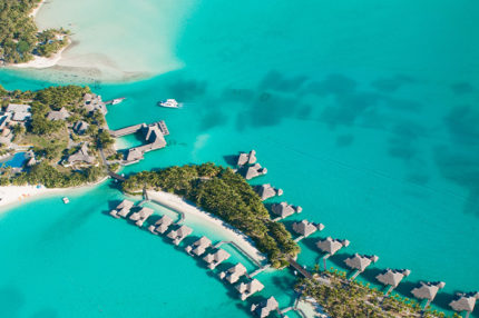 Aerial view of green water and bungalows, Bora Bora