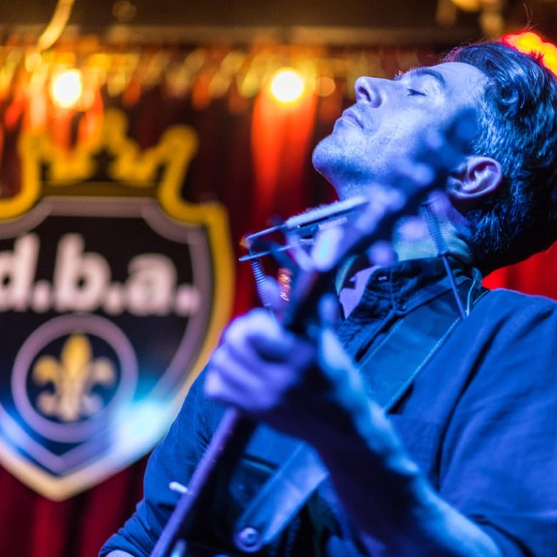 A guitarist playing at D.B.A