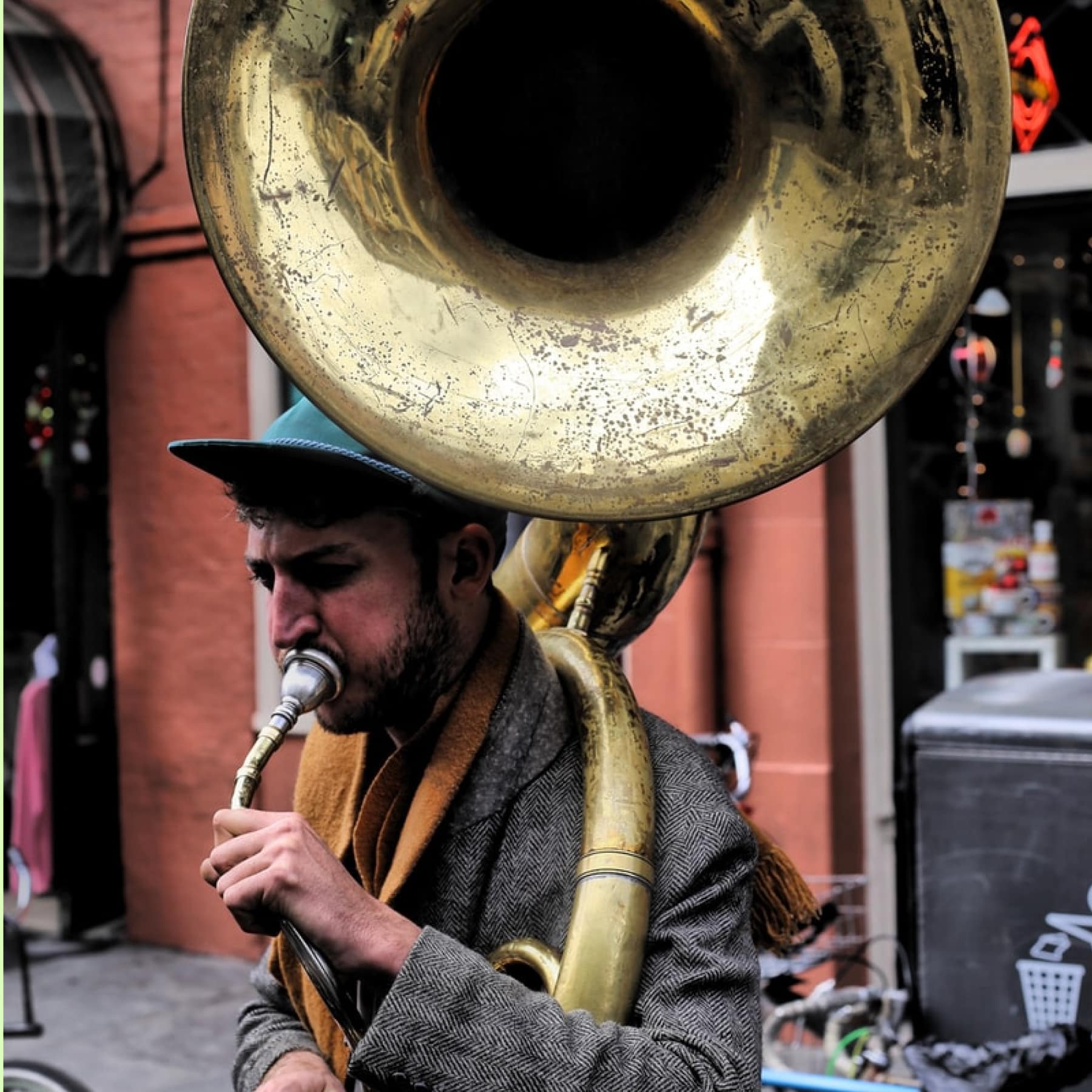 A man playing the trumpet on a sidewalk of New Orleans